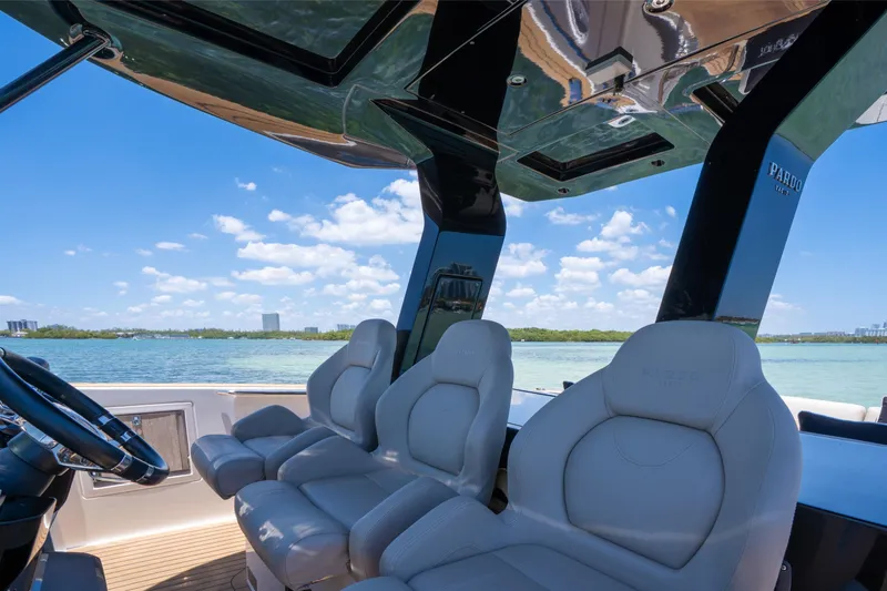 Slide: The Image of Luxury seating on 2020 Pardo Yachts 38, overlooking serene waters and blue sky. - 19