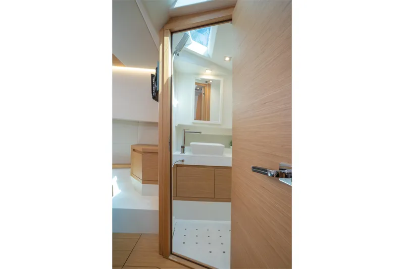 Slide: The Image of Modern bathroom interior on 2020 Pardo Yachts 38, featuring sleek wood finishes and skylight. - 21