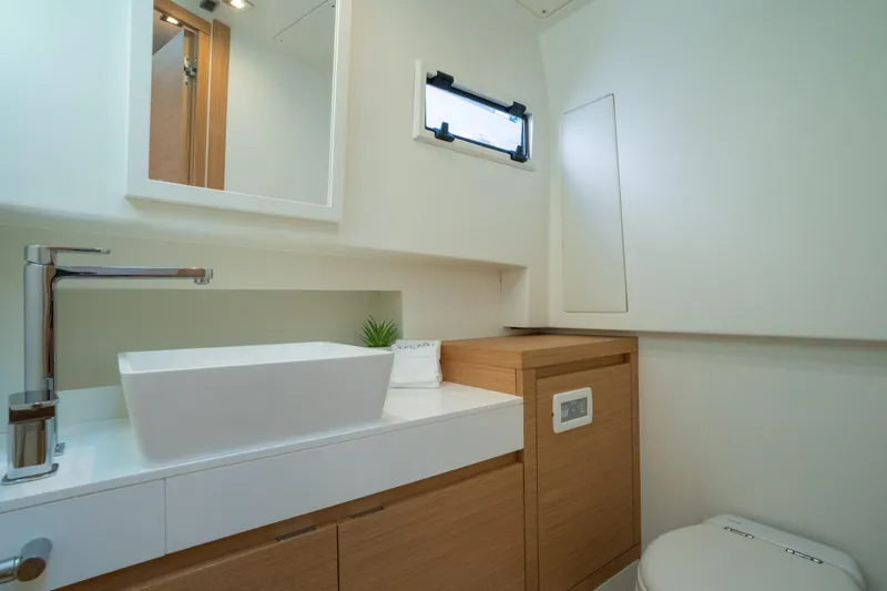 Slide: The Image of Modern bathroom interior on 2020 Pardo Yachts 38, featuring sleek sink and wooden cabinetry. - 22