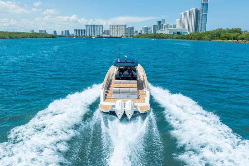 Slide: The Image of 2020 Pardo Yachts 38 cruising on blue water with city skyline backdrop. - 24