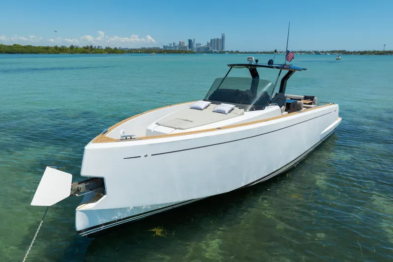 Slide: The Image of 2020 Pardo Yachts 38 anchored in clear blue water with city skyline in background. - 8