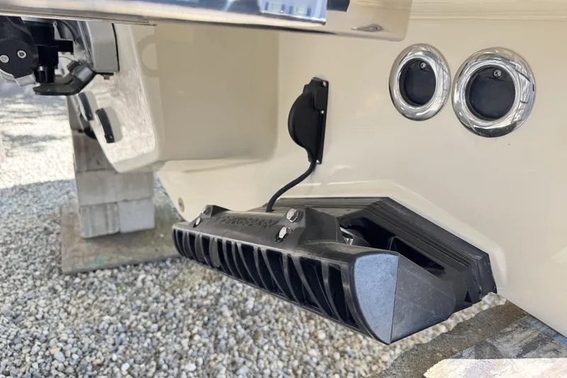 Slide: The Image of 2025 Chris-Craft Calypso 28 boat stern detail with dual exhaust ports and trim tab. - 11