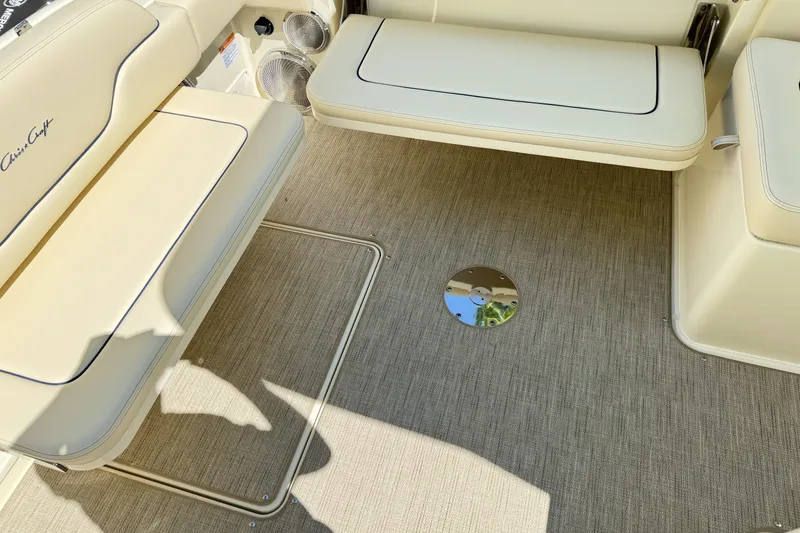 Slide: The Image of 2025 Chris-Craft Calypso 28 interior with beige seating and carpeted flooring. - 14
