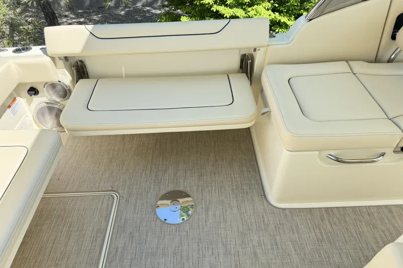 Slide: The Image of 2025 Chris-Craft Calypso 28 interior with beige seating and carpeted flooring. - 15