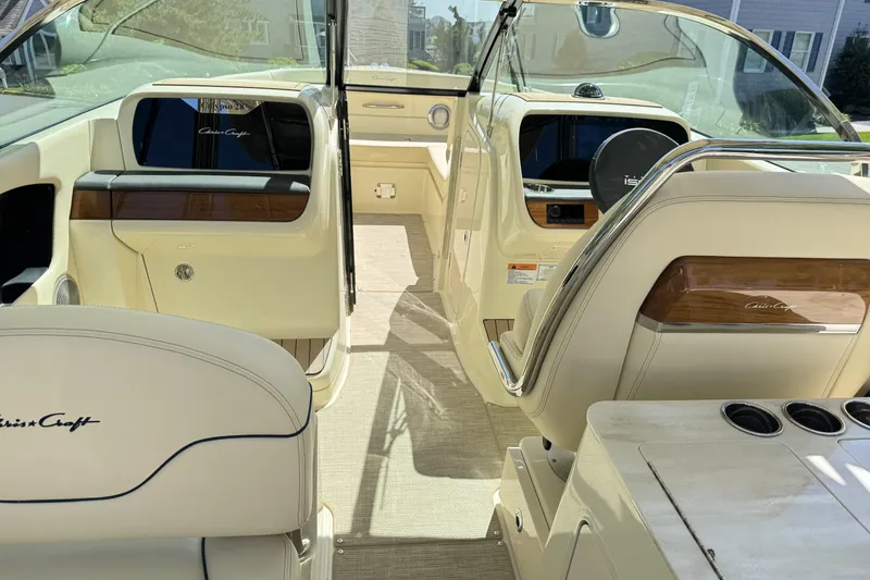 Slide: The Image of Interior of 2025 Chris-Craft Calypso 28 boat, featuring elegant seating and dashboard. - 16