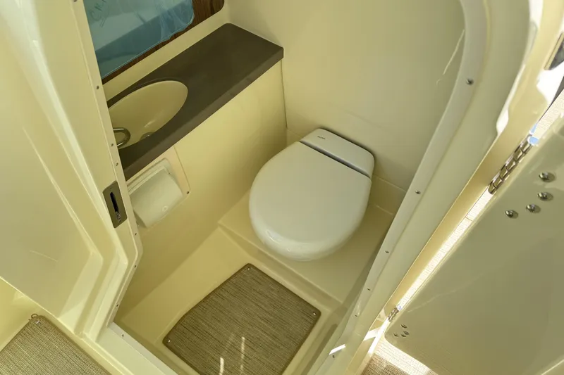 Slide: The Image of 2025 Chris-Craft Calypso 28 boat bathroom with toilet and sink. - 17