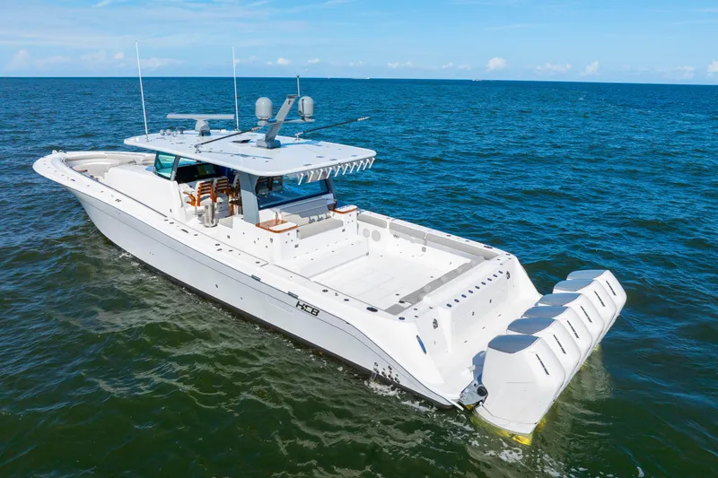 Slide: The Image of 2027 HCB 65 Estrella luxury yacht cruising on open sea under clear skies. - 10