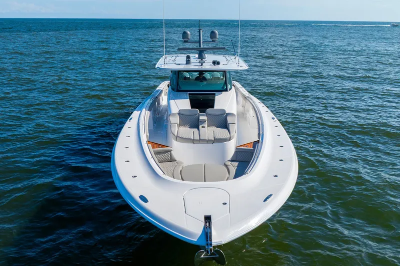 Slide: The Image of 2027 HCB 65 Estrella luxury boat on open water, showcasing sleek design and spacious deck. - 13