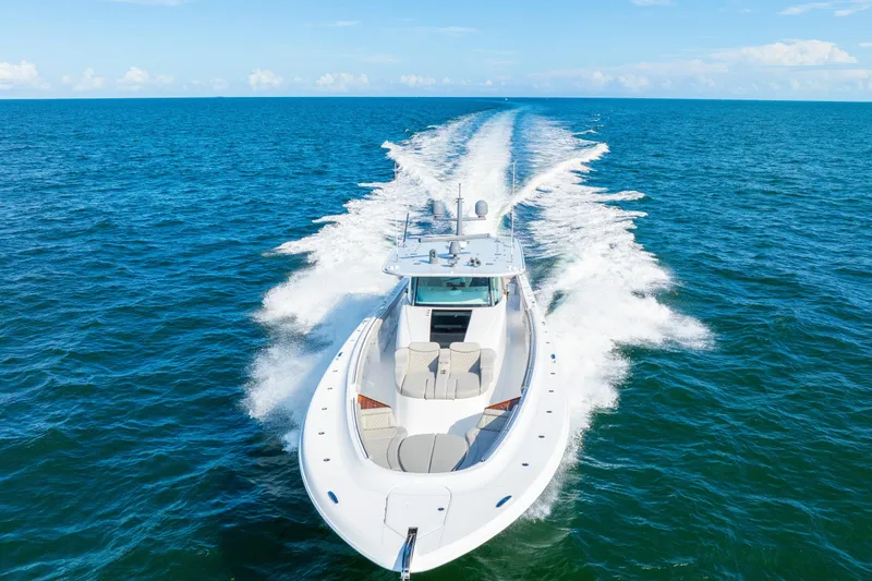 Slide: The Image of 2027 HCB 65 Estrella yacht cruising on open ocean under clear blue sky. - 16