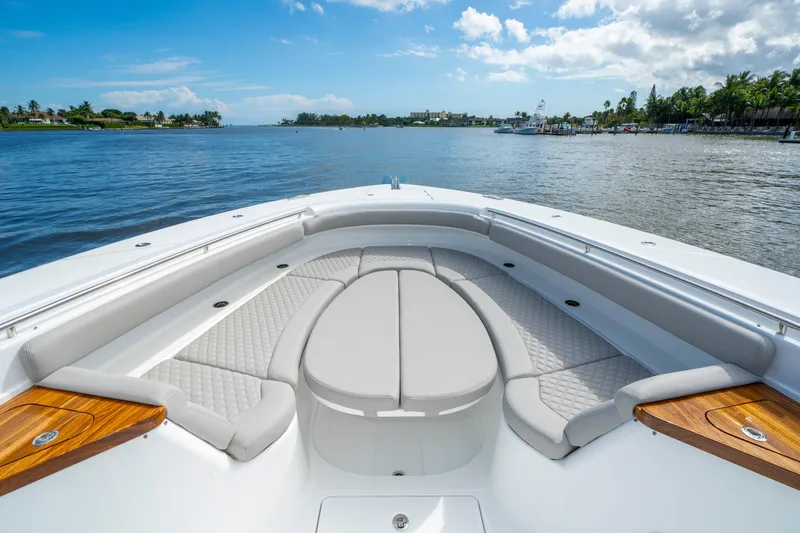 Slide: The Image of Luxurious 2027 HCB 65 Estrella boat interior with elegant seating and scenic water view. - 22