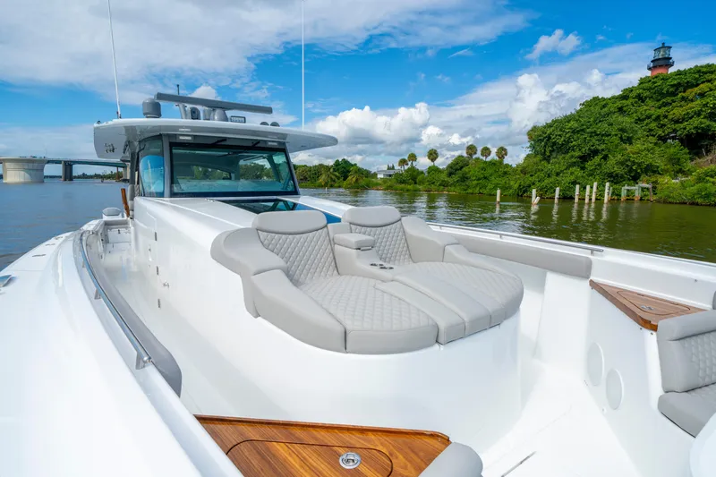 Slide: The Image of Luxurious 2027 HCB 65 Estrella yacht with plush seating, cruising on a scenic river. - 24