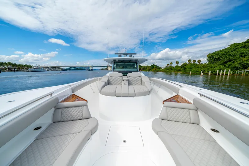 Slide: The Image of Luxurious 2027 HCB 65 Estrella yacht with spacious seating, cruising on a scenic waterway. - 27