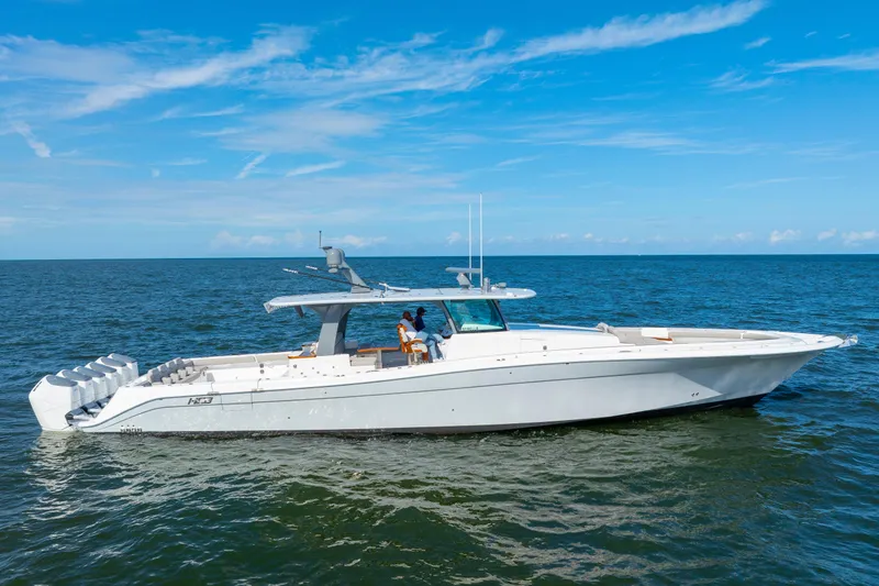 Slide: The Image of 2027 HCB 65 Estrella luxury yacht cruising on open sea under clear blue sky. - 3