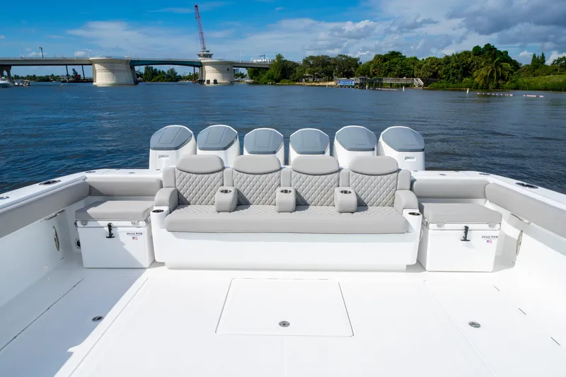 Slide: The Image of 2027 HCB 65 Estrella boat with luxurious seating, on a scenic waterfront backdrop. - 31