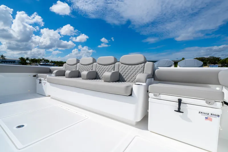 Slide: The Image of Luxurious seating on 2027 HCB 65 Estrella boat under a bright blue sky. - 32