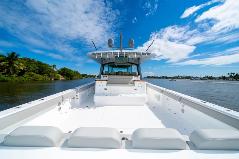 Slide: The Image of Luxury HCB 65 Estrella yacht on serene water, clear blue sky, 2027 model. - 36