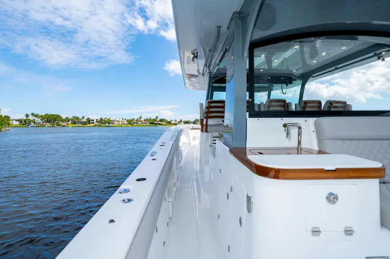 Slide: The Image of 2027 HCB 65 Estrella yacht with sleek design, luxurious seating, and waterfront view. - 40
