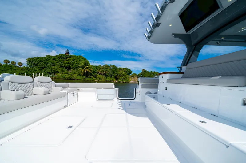 Slide: The Image of Luxurious 2027 HCB 65 Estrella yacht deck with plush seating, scenic waterfront view. - 42