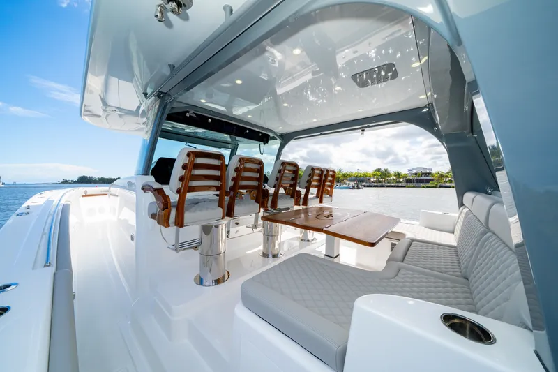 Slide: The Image of Luxurious 2027 HCB 65 Estrella yacht interior with elegant seating and table, overlooking serene waters. - 46
