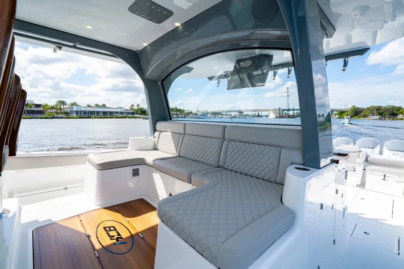 Slide: The Image of Luxurious seating area on the 2027 HCB 65 Estrella yacht, overlooking a scenic waterfront. - 53
