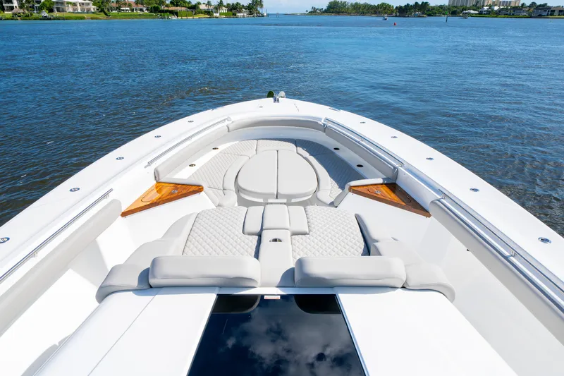 Slide: The Image of Luxurious 2027 HCB 65 Estrella yacht with spacious deck and elegant seating on calm waters. - 60