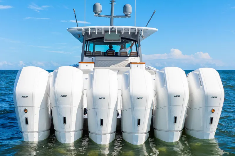 Slide: The Image of 2027 HCB 65 Estrella boat with six powerful outboard engines on open water. - 68