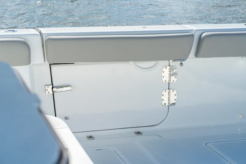 Slide: The Image of 2027 HCB 65 Estrella boat interior with sleek white seating and water view. - 72