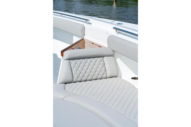 Slide: The Image of Luxurious seating on the 2027 HCB 65 Estrella boat, featuring quilted upholstery. - 77