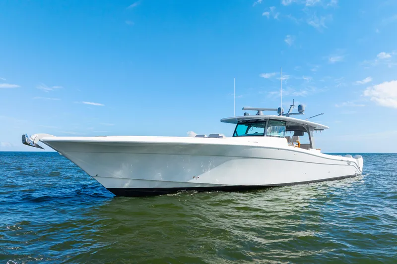 Slide: The Image of 2027 HCB 65 Estrella luxury yacht cruising on open water under clear blue skies. - 8