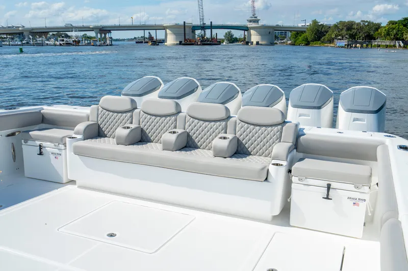 Slide: The Image of Luxury seating on 2027 HCB 65 Estrella boat with scenic waterfront view. - 83