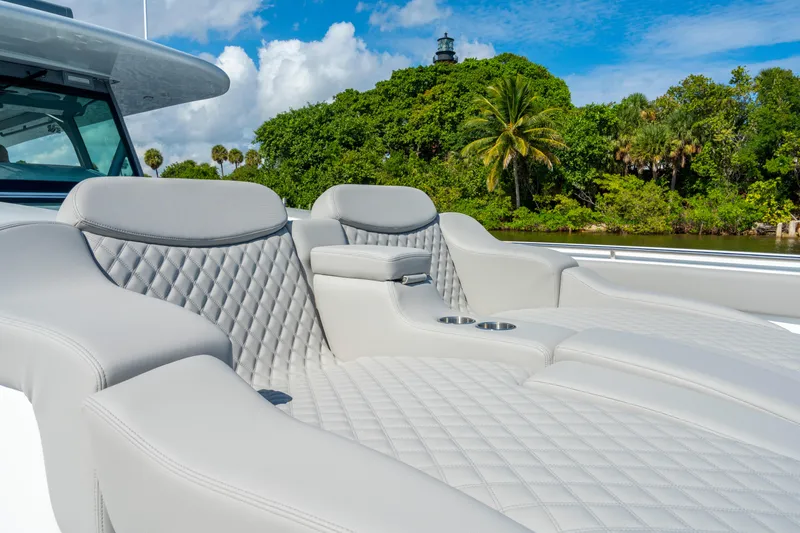 Slide: The Image of Luxurious seating on 2027 HCB 65 Estrella yacht with lush greenery backdrop. - 86