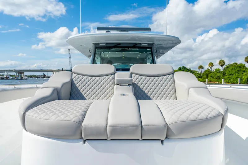 Slide: The Image of Luxurious seating on the 2027 HCB 65 Estrella yacht, featuring quilted upholstery and scenic views. - 87