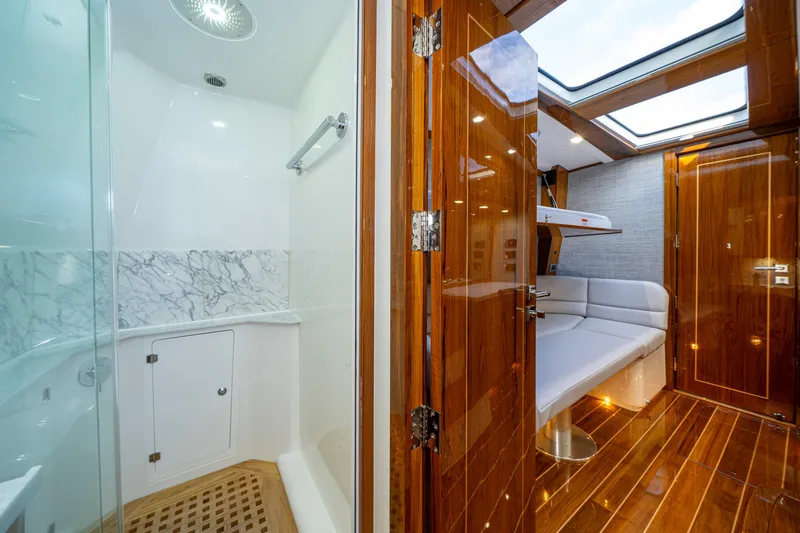 Slide: The Image of Luxurious interior of 2027 HCB 65 Estrella yacht featuring shower and seating area. - 90