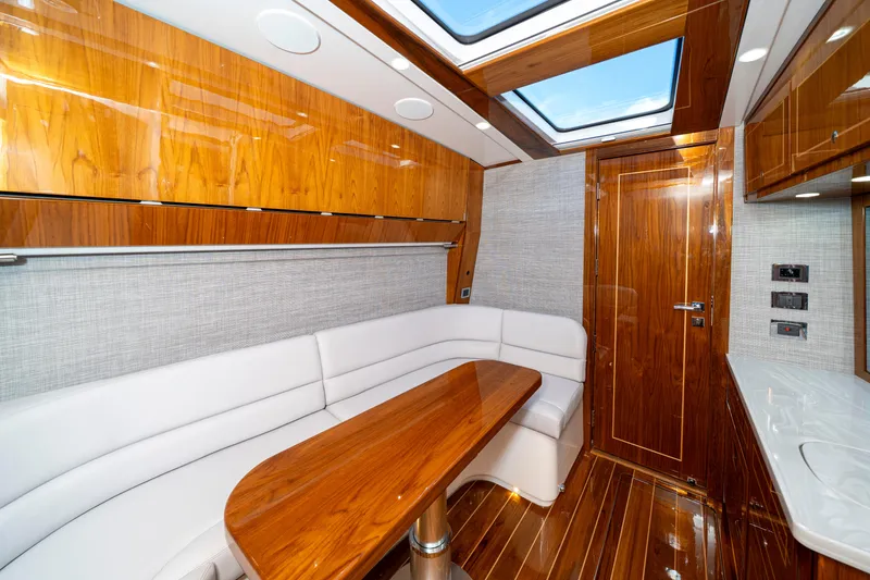 Slide: The Image of Luxurious interior of 2027 HCB 65 Estrella yacht with wood finishes and white seating. - 93