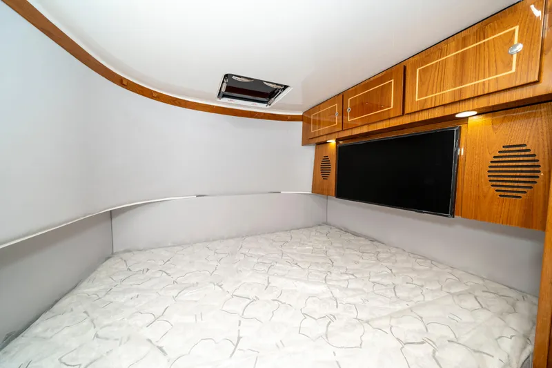 Slide: The Image of Interior cabin of 2027 HCB 65 Estrella with wood cabinets and bed. - 96