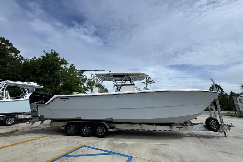 Slide: The Image of 2020 Invincible 35 Catamaran on trailer, parked outdoors under cloudy sky. - 10