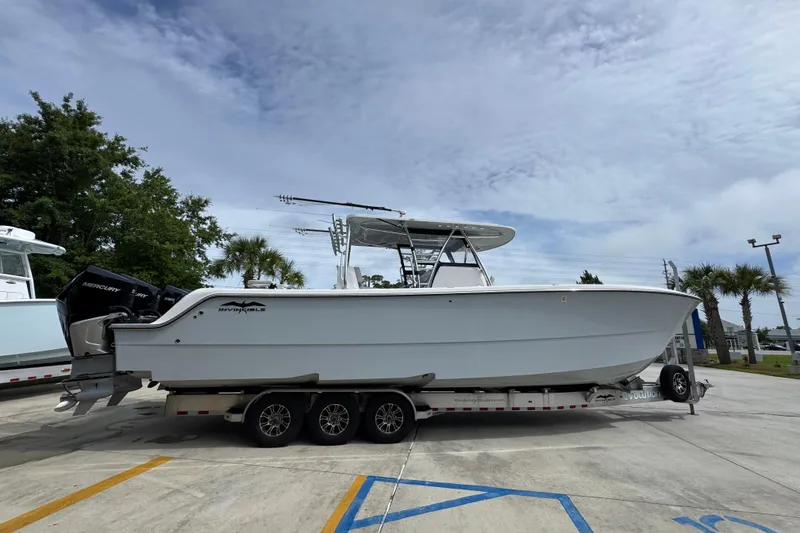 Slide: The Image of 2020 Invincible 35 Catamaran on trailer, parked outdoors under cloudy sky. - 11