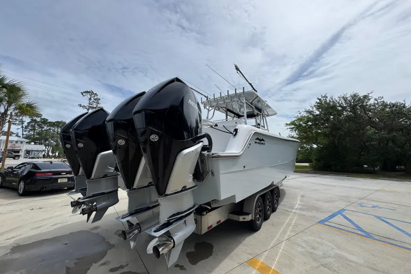 Slide: The Image of 2020 Invincible 35 Catamaran with triple Mercury outboard engines on a trailer. - 14