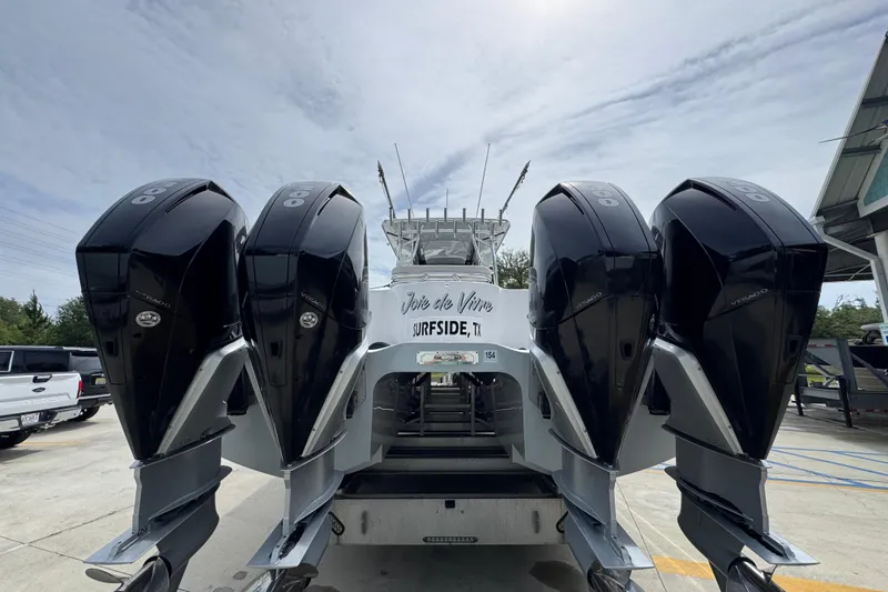 Slide: The Image of 2020 Invincible 35 Catamaran with four powerful outboard engines, parked outdoors. - 15