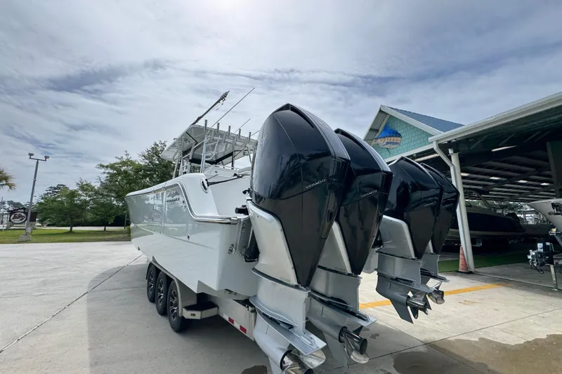 Slide: The Image of 2020 Invincible 35 Catamaran with triple outboard engines on a trailer. - 16