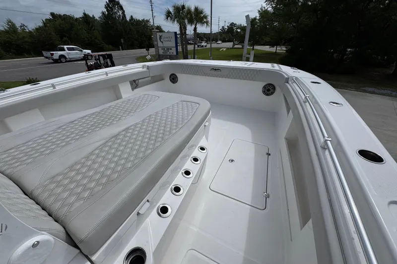 Slide: The Image of 2020 Invincible 35 Catamaran interior with cushioned seating and storage compartments. - 18