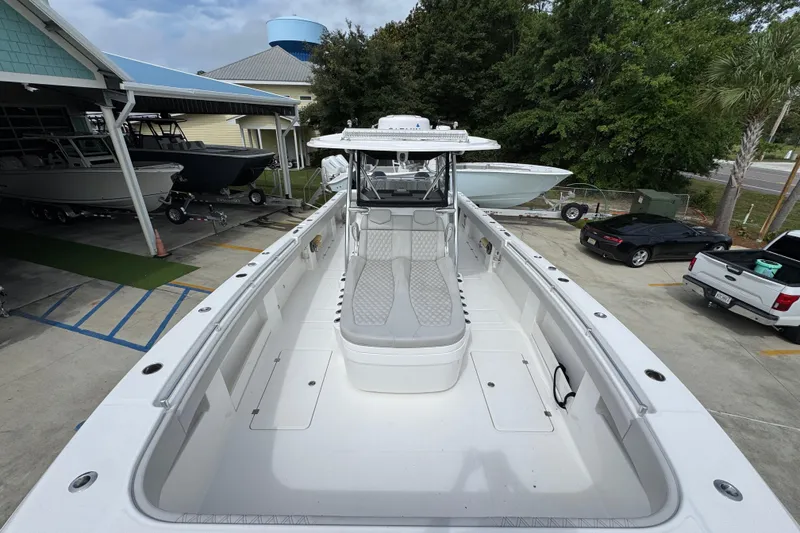Slide: The Image of 2020 Invincible 35 Catamaran in a marina, showcasing spacious deck and sleek design. - 22
