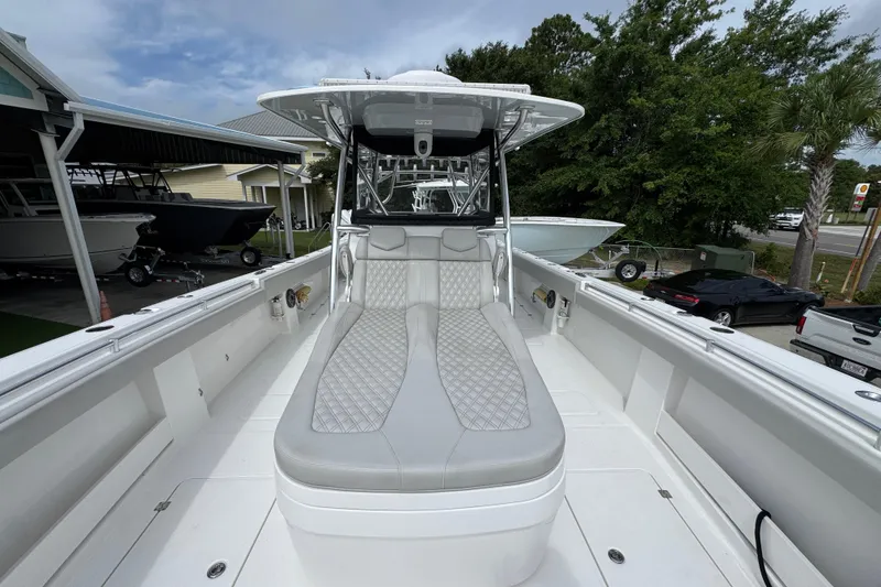 Slide: The Image of 2020 Invincible 35 Catamaran with cushioned seating, docked outdoors. - 23
