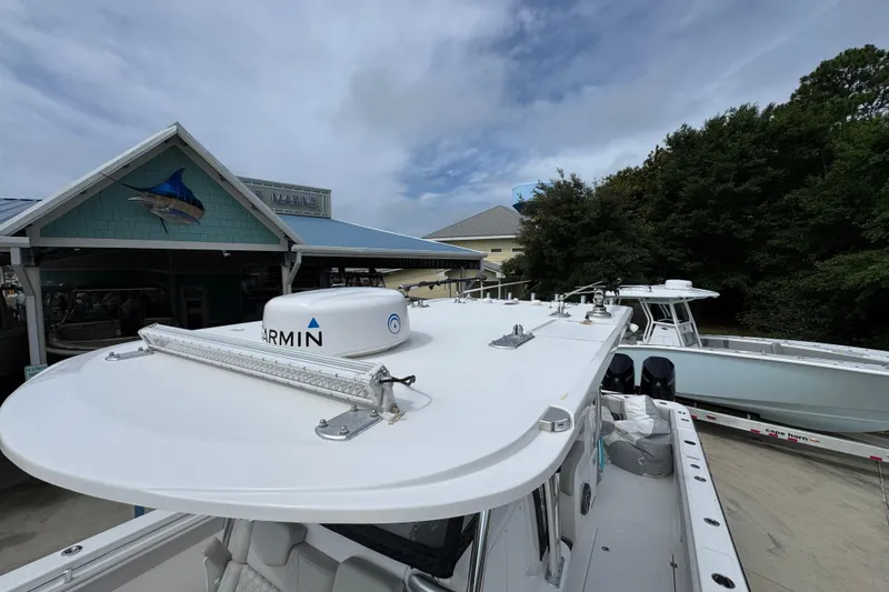 Slide: The Image of 2020 Invincible 35 Catamaran docked near marine building under cloudy sky. - 24