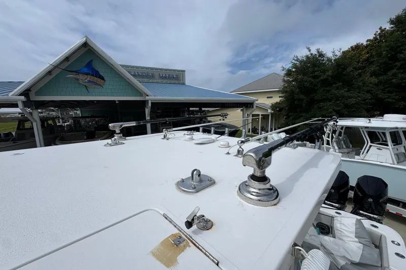 Slide: The Image of 2020 Invincible 35 Catamaran at a marina with fishing gear and boats. - 25