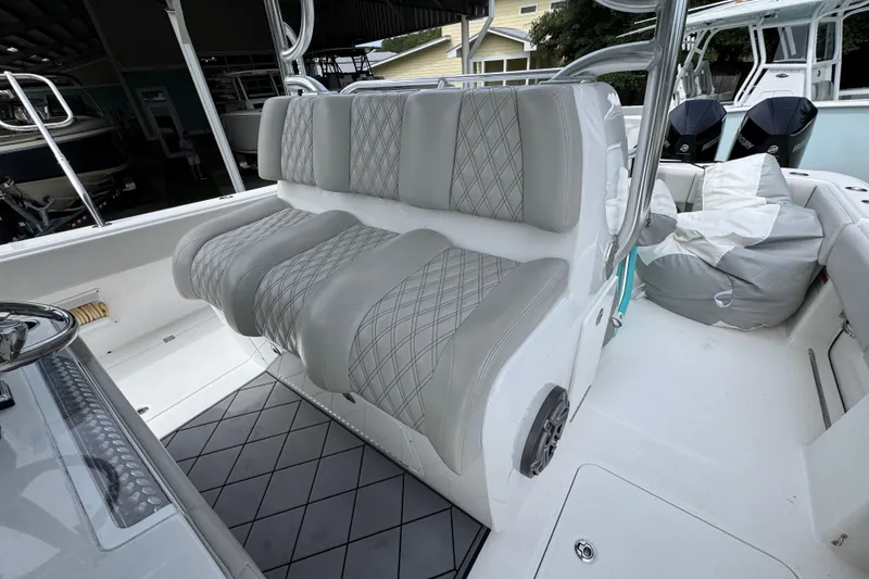 Slide: The Image of Luxurious seating on a 2020 Invincible 35 Catamaran, featuring diamond-stitched upholstery. - 28