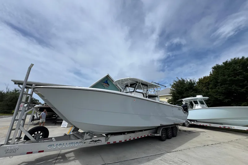 Slide: The Image of 2020 Invincible 35 Catamaran on trailer under cloudy sky, ready for transport. - 3
