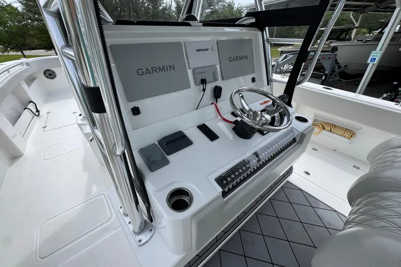 Slide: The Image of Helm of 2020 Invincible 35 Catamaran featuring Garmin navigation and modern controls. - 32