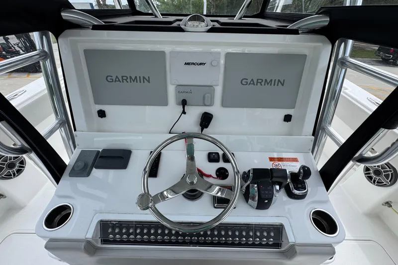 Slide: The Image of Helm of 2020 Invincible 35 Catamaran with Garmin displays and Mercury controls. - 33