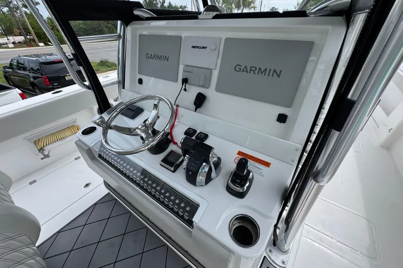Slide: The Image of Control panel of a 2020 Invincible 35 Catamaran with Garmin navigation systems. - 35